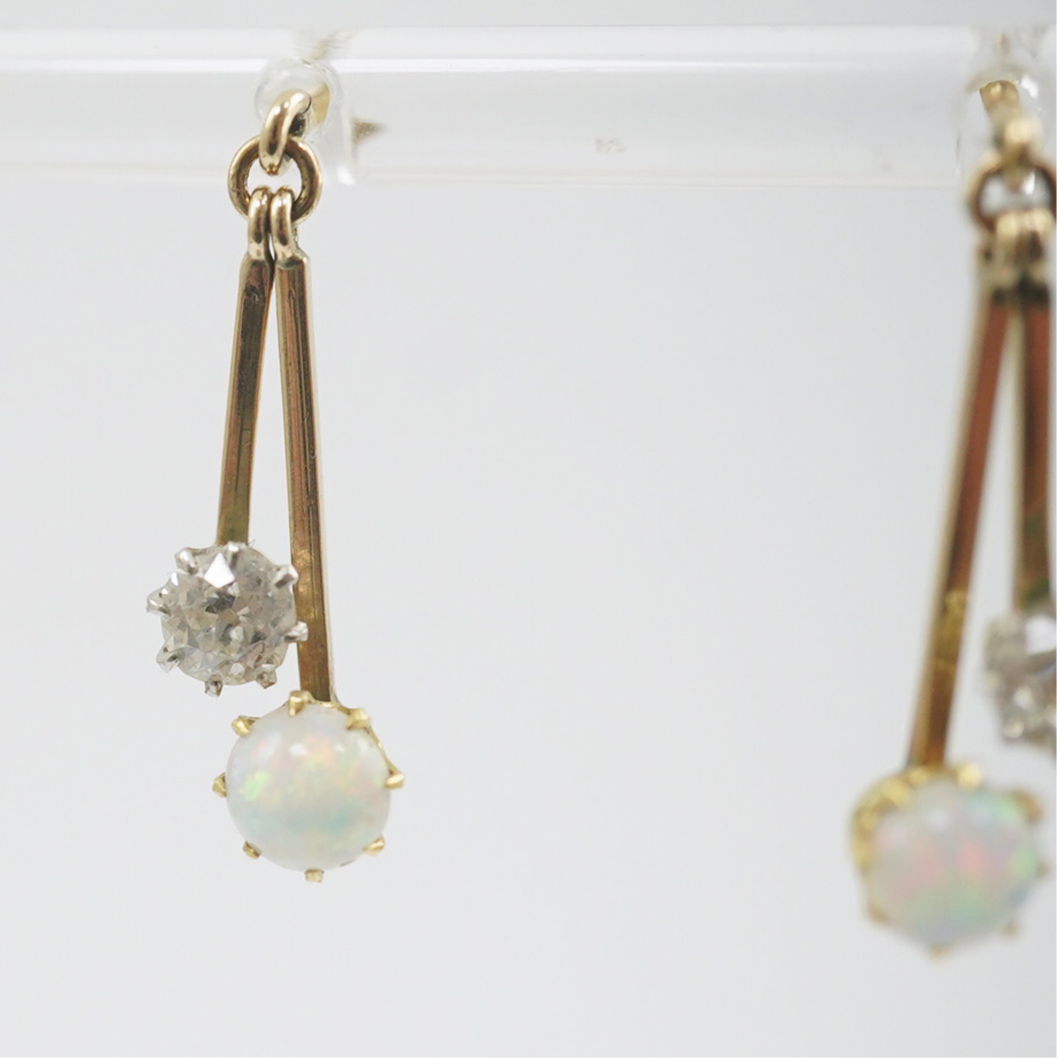 A pair of 9ct gold, white opal and diamond set double drop earrings